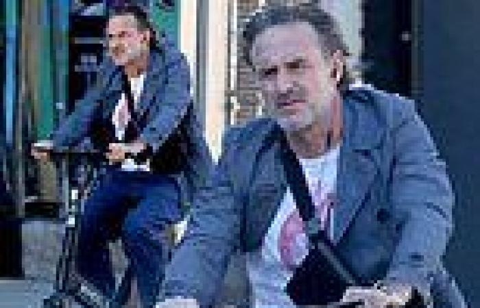 David Arquette listens to music as he whizzes through West Hollywood on an ...