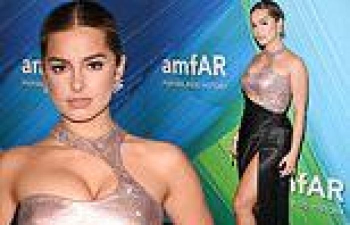 Addison Rae puts her cleavage front and center in a silky black gown at amfAR ...