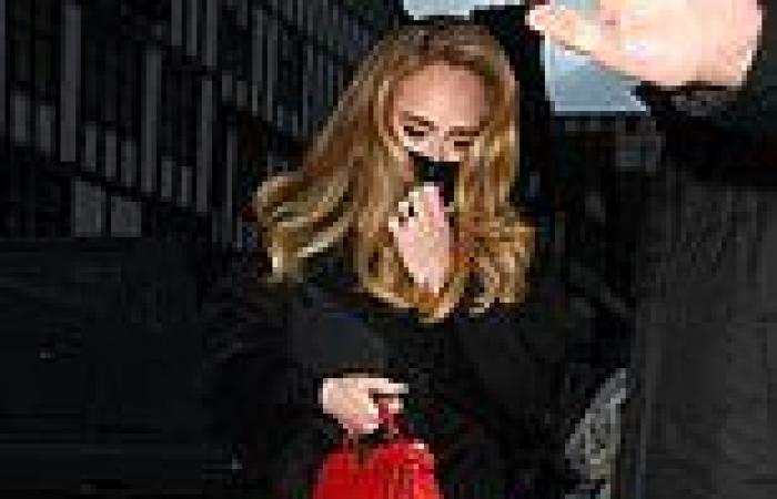 Adele sports a band on her wedding finger leaving a studio in London