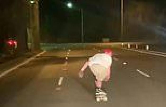 Insane moment a thrill-seeking skateboarder weaves across a dangerous main road ...