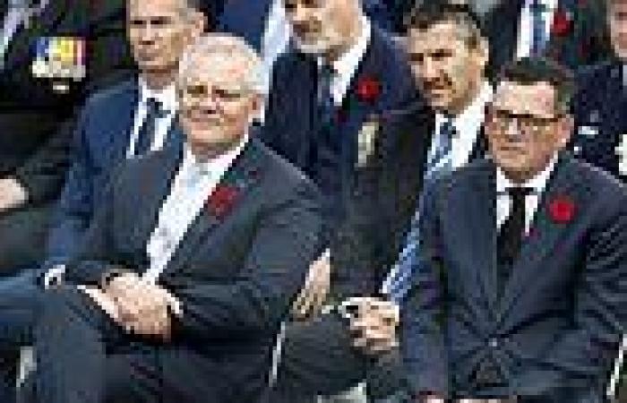 Scott Morrison and Dan Andrews sit together at Remembrance Day event