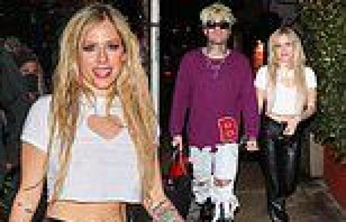 Avril Lavigne flaunts her tiny waist and taut abs in a cut-out white crop top
