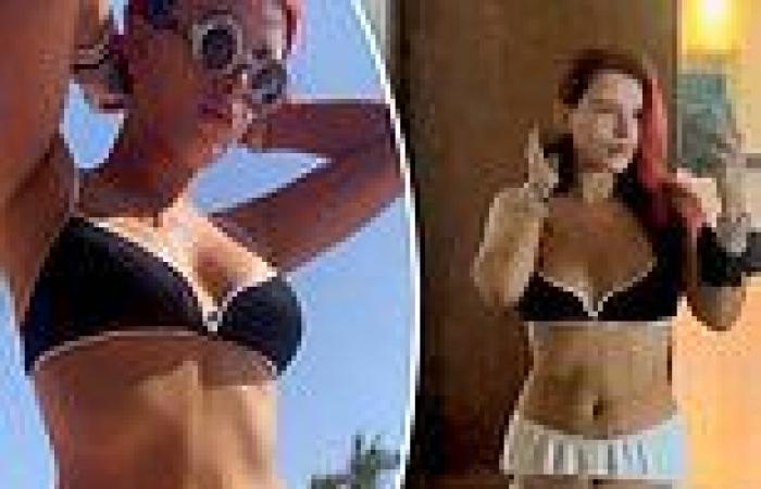 Bella Thorne studies her flawless figure and taut tummy in a black bikini while ...