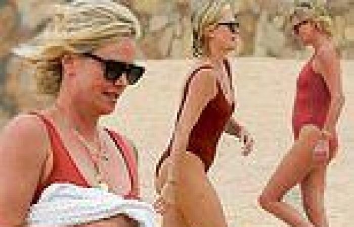 Charlize Theron puts her beach body on full display in sexy orange-red swimsuit