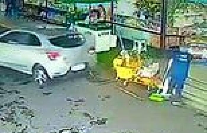 Moment cleaner is almost mown down as she sweeps supermarket car park in Brazil ...