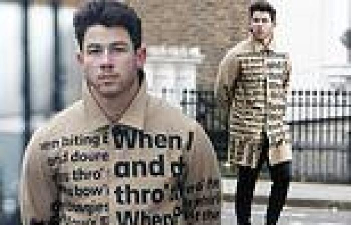 Nick Jonas wraps up in a word print coat as he enjoys a stroll through London's ...