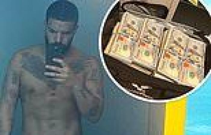 Drake reveals his chiseled abs as he shows off his massive stacks of cash