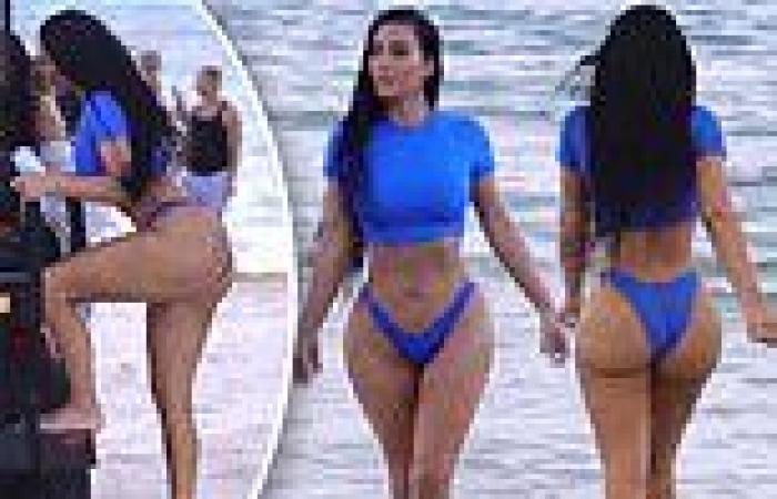 Kim Kardashian showcases her famous hourglass curves in a bright blue bikini ...