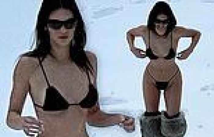 Kendall Jenner plays in the snow wearing a tiny black string bikini while on ...