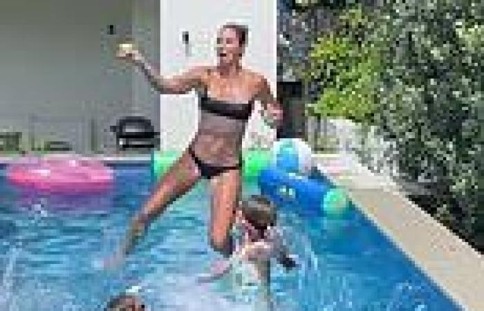 Candice Warner shows off her ripped figure in a black bikini as she jumps into ...