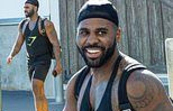 Jason Derulo grins as he shows off his bulging biceps while leaving the gym