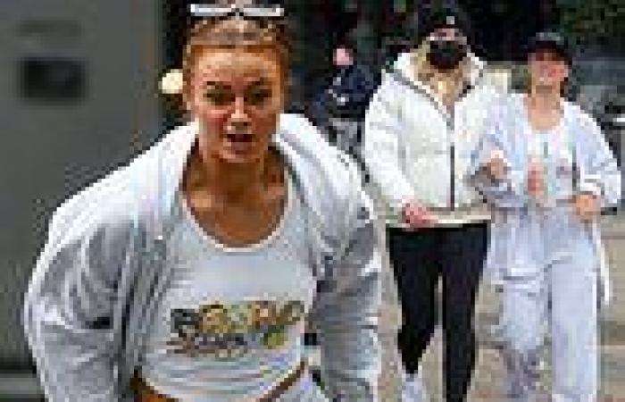 Maisie Smith sprints across a road to link arms with pal Tilly Ramsay