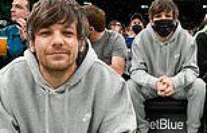 Louis Tomlinson goes casual in gray sweats as he watches the Boston Celtics ...