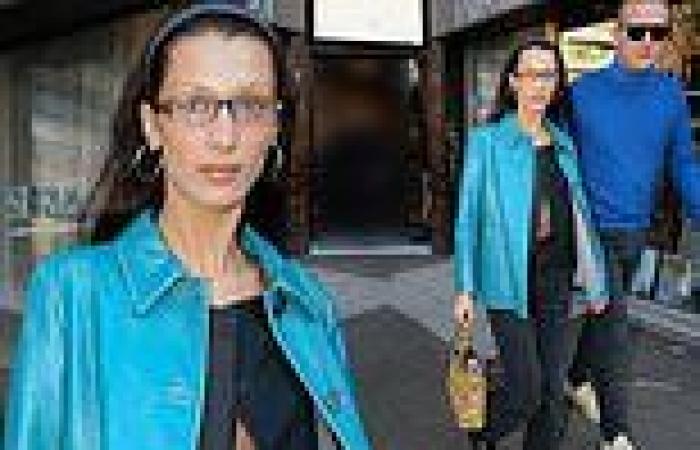 Bella Hadid flashes her abs in double denim and a vibrant blue jacket as she ...
