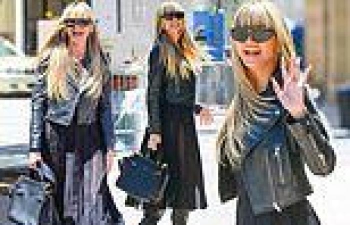 Heidi Klum flashes her pert derriere in sheer black dress with a leather jacket