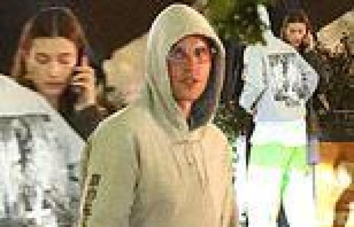 Justin Bieber wears his own tour hoodie during dinner with Hailey