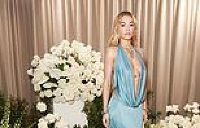 Rita Ora flashes her cleavage in a plunging blue silk gown at British Vogue ... trends now