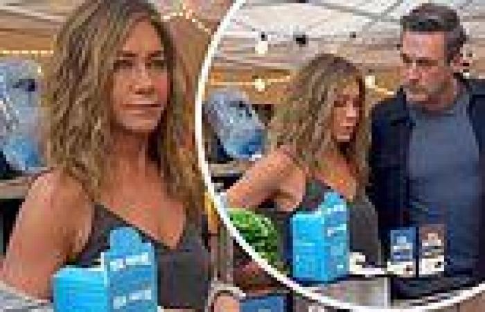 Jennifer Aniston lets her cardigan fall off her  shoulders as she chats up Jon ... trends now