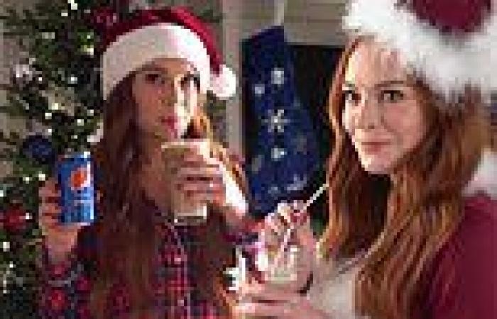 Lindsay Lohan models a Santa hat as she makes a 'dirty soda' that consists of ... trends now