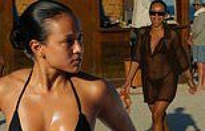 Karrueche Tran bares her oiled chest in skimpy black bikini while soaking up ... trends now
