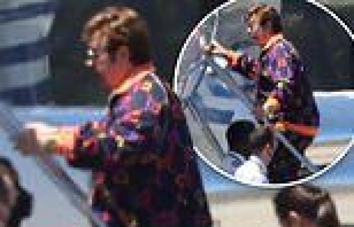 Elton John, 75, dons a Gucci tracksuit as he steps aboard a private jet trends now