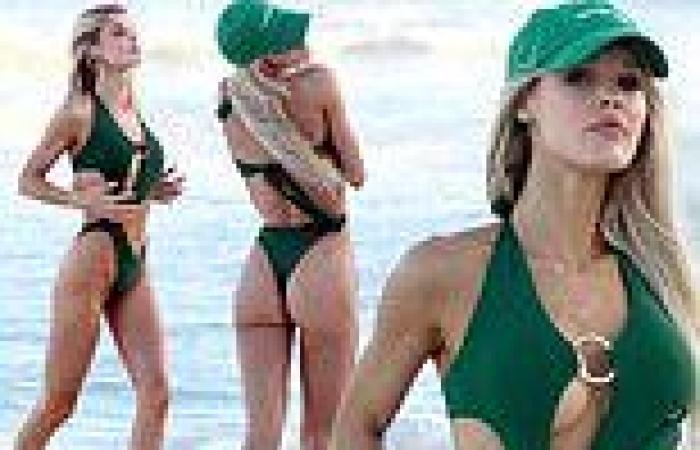 Joy Corrigan leaves little to the imagination in a strappy swimsuit as she ... trends now