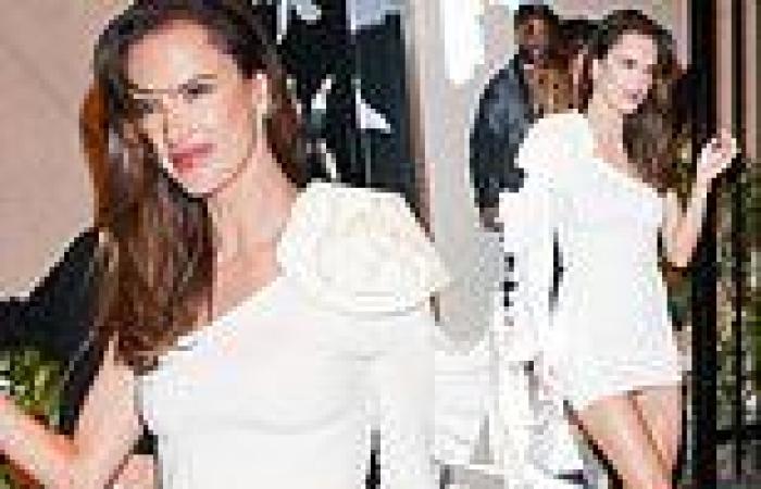 Alessandra Ambrosio puts her long legs on display in a white asymmetrical ... trends now