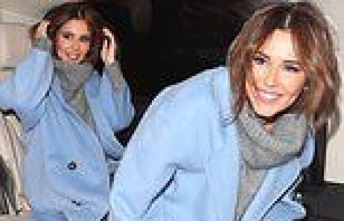 Cheryl wraps up in a turtleneck jumper and powder blue coat trends now