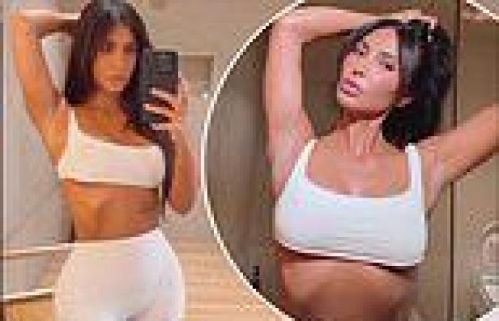 Kim Kardashian shows off her ultra-toned figure in a white shorts and crop top ... trends now
