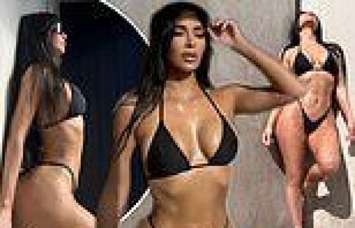 Kim Kardashian, 42, models a skimpy black bikini with a gold cross belly chain trends now