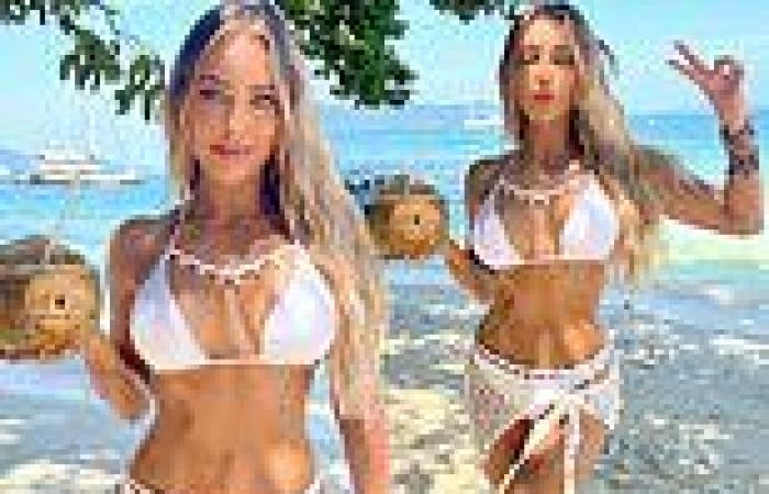 TOWIE's Amber Turner showcases her toned figure in a white shell bikini trends now
