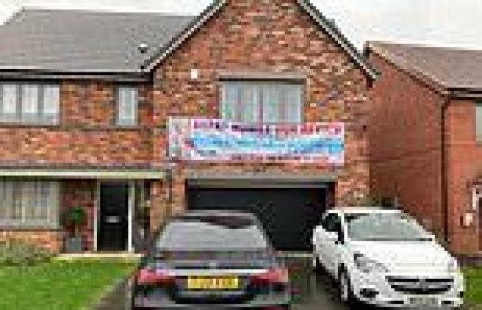 Man erects giant banner above his garage in row between him and the developer trends now