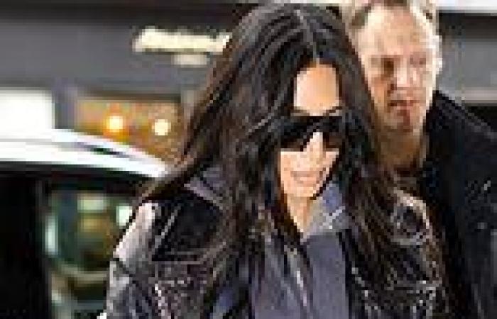 Kim Kardashian cuts a chic figure in a black leather trench coat as she shops ... trends now