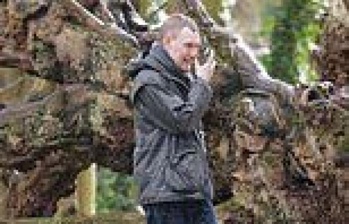 David Gray enjoys a dog walk during a rare outing in a London park trends now