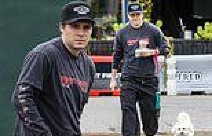 Brooklyn Beckham cuts a casual figure in a Foo Fighters T-shirt on a dog walk ... trends now