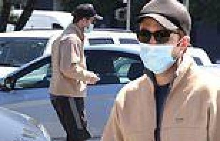 Robert Pattinson obscures face behind shades and a mask as he surfaces for ... trends now