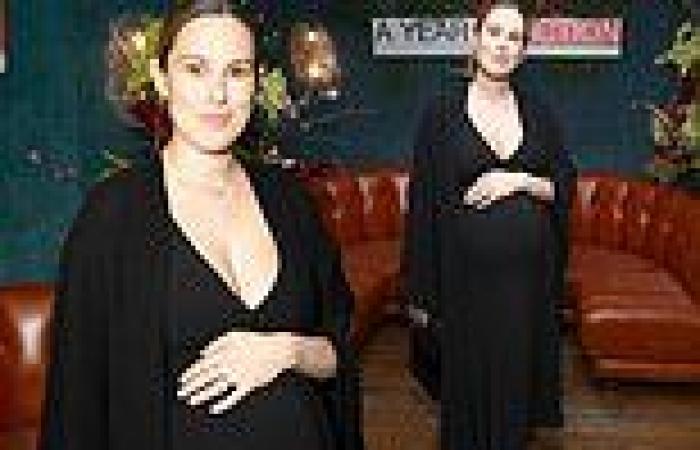 Pregnant Rumer Willis cradles her burgeoning baby bump in a fitted black dress trends now