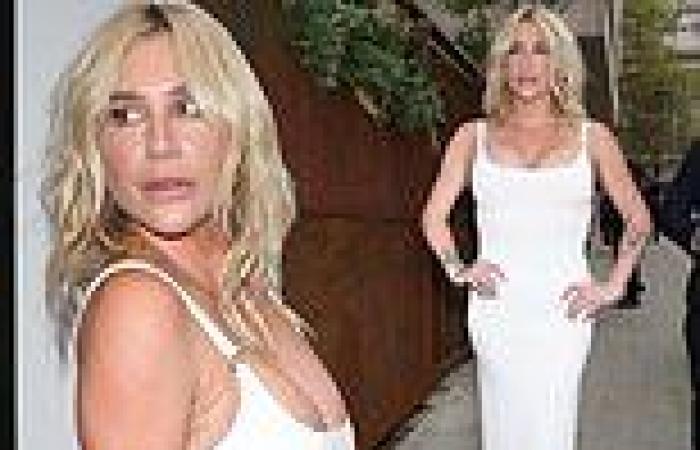 Kesha struggles to contain her ample cleavage in a plunging white dress trends now