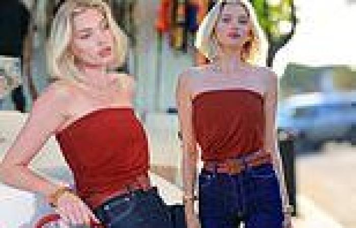 Elsa Hosk keeps it simple in red strapless top and dark denim jeans at FWRD ... trends now