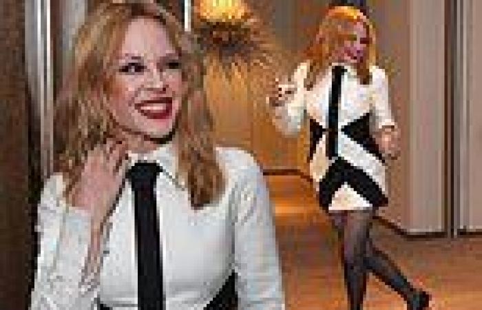 Kylie Minogue slips into a black and white shirt dress and tie as she dances ... trends now