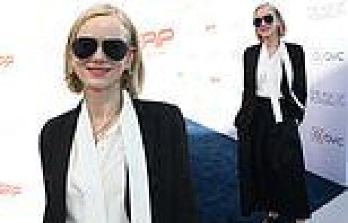 Naomi Watts wears a classic tailored  black and ivory outfit as she attends ... trends now