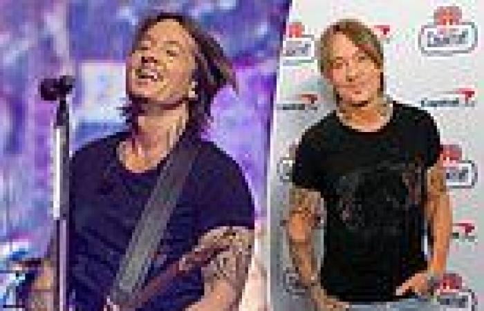 Keith Urban shows off his bulging biceps and rockstar tattoos in a tight black ... trends now