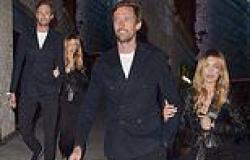 Abbey Clancy cuts a stylish figure in a sexy black dress as she links arms with ... trends now