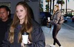 Lana Del Rey cuts a cheerful figure in tight leggings and black padded coat as ... trends now