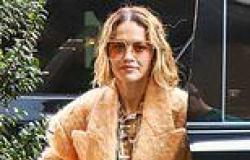 Rita Ora stuns in a sweeping orange coat and matching co-ord as she attends a ... trends now