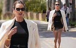 Alessandra Ambrosio puts on a VERY leggy display in a black top and short ... trends now