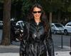Bella Hadid displays her edgy sense of style in a black leather trench coat on ...