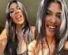 Kourtney Kardashian shows off bejeweled teeth as she flashes cleavage in black ...