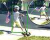 Viral video showing young boy pulling up an American flag from a lawn and ...