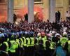 Lines of riot police guard Trafalgar Square as England fans take to the streets